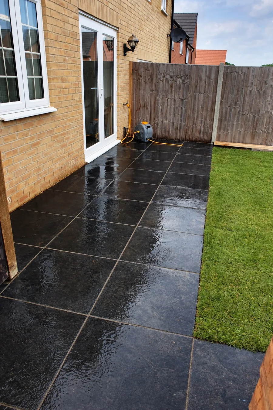 Black porcelain paving path along a house and lawn