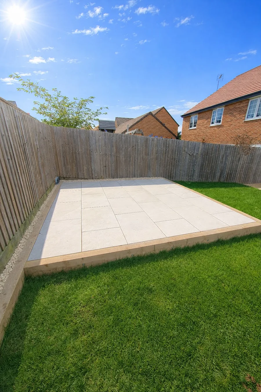 Finished patio and lawn landscaping in a fenced garden
